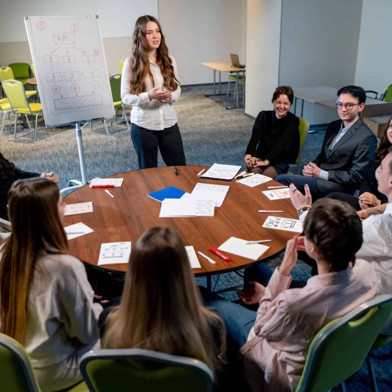business conference or meeting at the hotel the girl on the flipchart shows the development plan for company