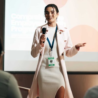 Business woman, conference and training for speaker in seminar room for wellness presentation. Educ.